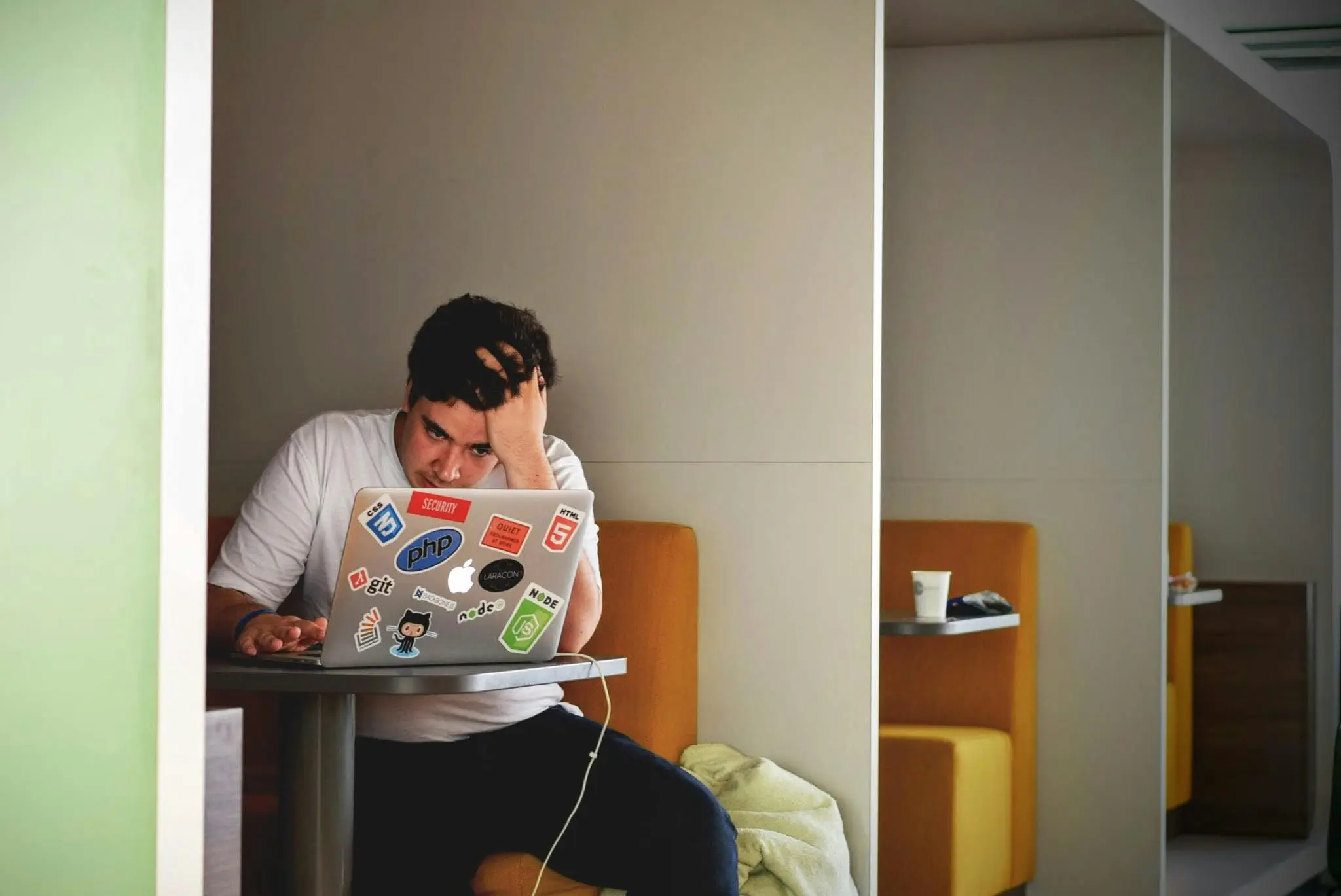 Man looking frustrated on his computer and contemplating if he should try Ketamine for ADHD.