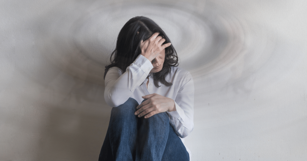 a woman cradling her head while contemplating ketamine for migraines.