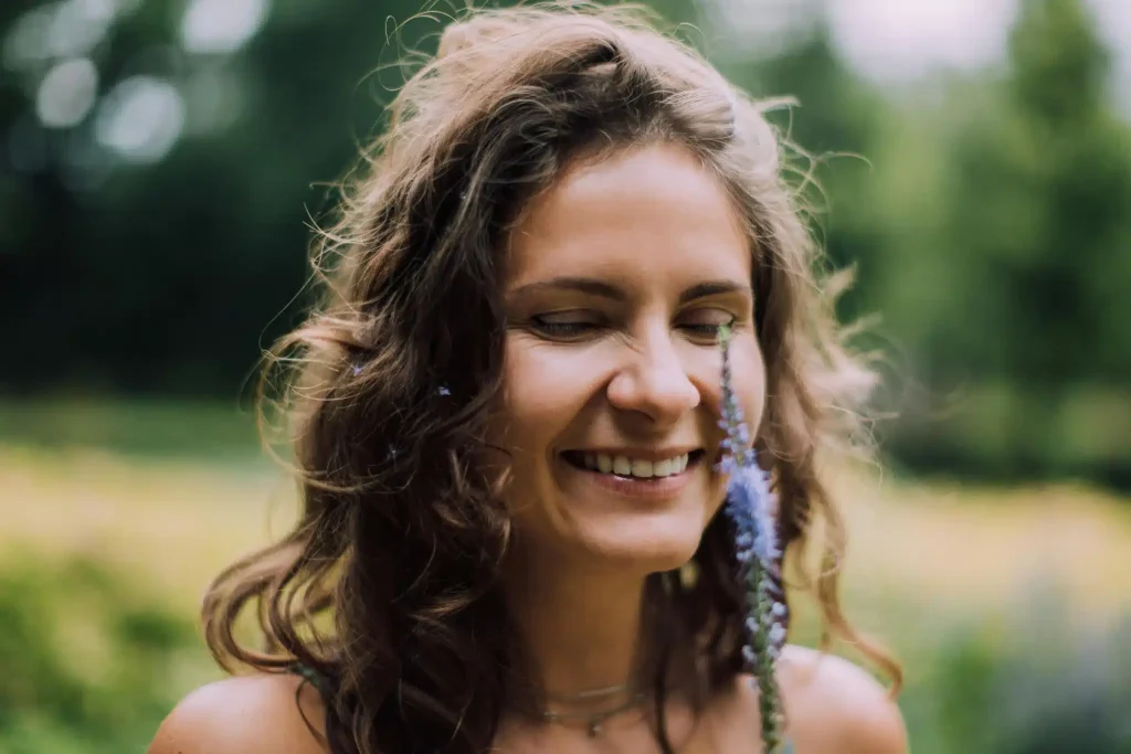 A woman smiles in relief on having her questions answered on if ketamine is a psychedelic at Ketamine Therapy at Therapeutic Alternatives.