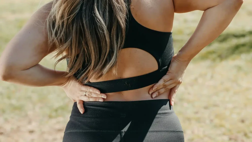 A woman in athletic clothing is shown from behind contemplating if ketamine is an opioid.