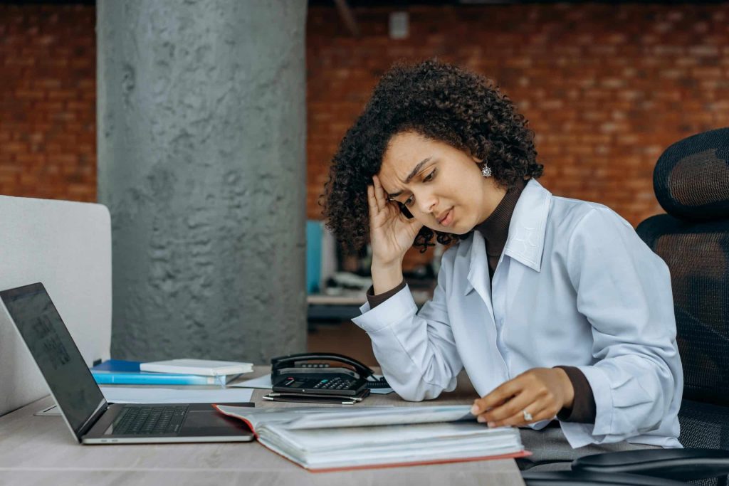 Woman stressed out at work and thinking about using ketamine for burnout.