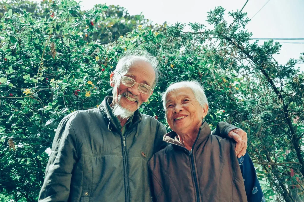 Elderly couple smiling outdoors after ketamine for end-of-life care in West Jordan.