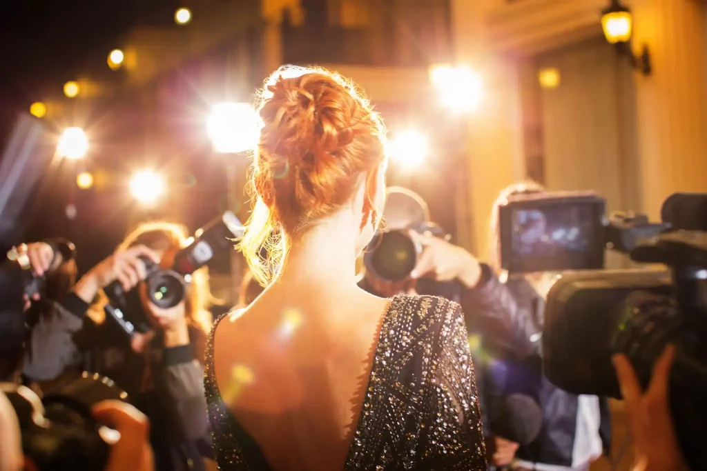 A celebrity surrounded by a flock of photographers asking about ketamine therapy for celebrities.