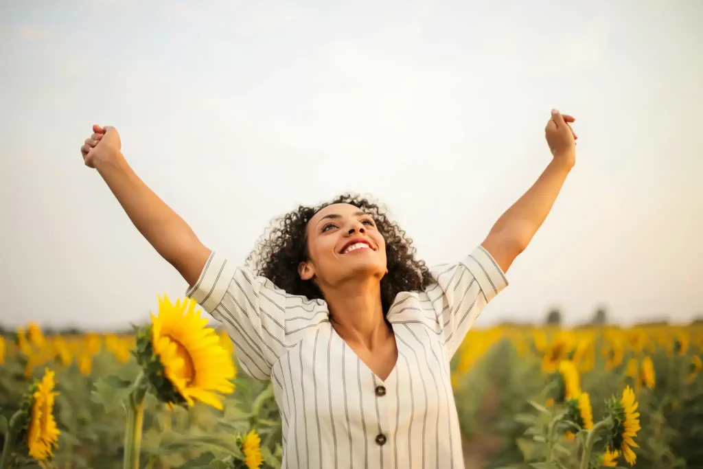 A woman smiles in relief after getting clarity on ketamine vs SSRIs at Ketamine Therapy at Therapeutic Alternatives.